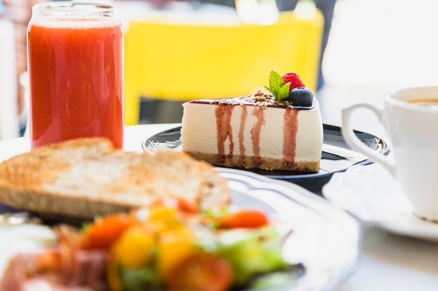 Smoothie; berry cheesecake and breakfast on table