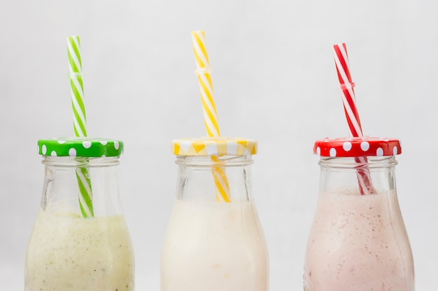 Free photo smoothie bottles with straw