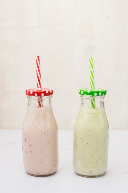 Free photo smoothie bottles with straw