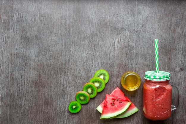 Smoothie of watermelon and kiwi on wooden background