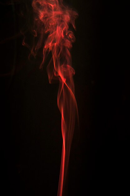 Smoothly flowing smoke against black background
