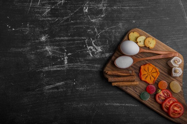 Snack board with chips, crackers and pastries on the wooden platter