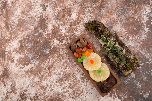 Snack and dry ftuis platter with herbs aside on the marble