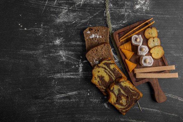 Snack and pastry board with sliced cake