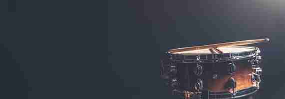 Free photo snare drum on a dark background isolated with space for a text