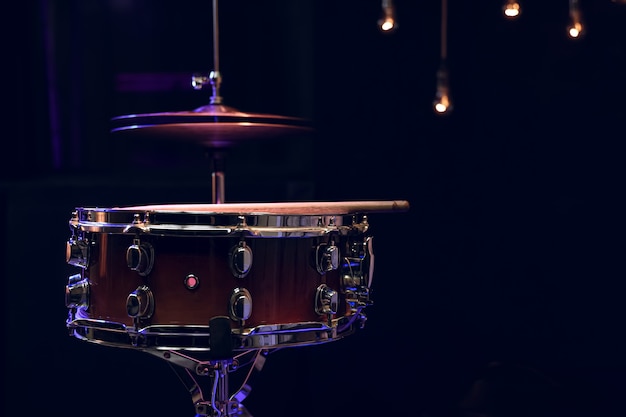 Snare drum in the dark with copy space. Musical creativity concept.