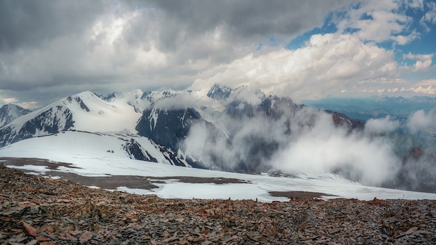 Premium Photo Giant Mountains With Snow Above White Clouds In Sunny