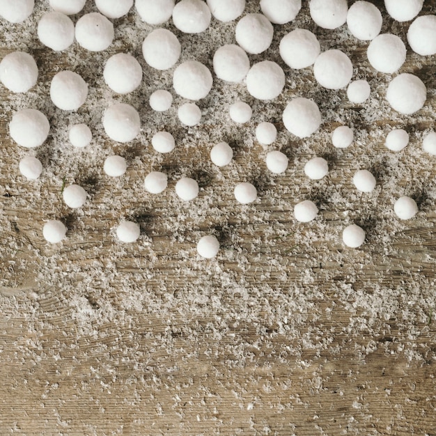 Free photo snowballs over wooden background for christmas