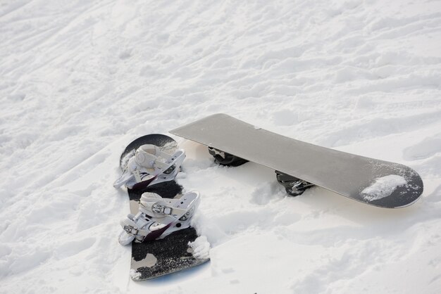 Snowboard on snowy slope in ski resort