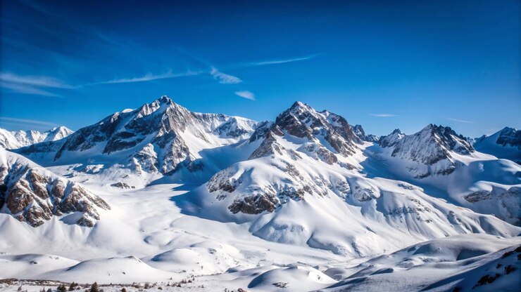 Snowcapped mountain peaks against a clear blue sky