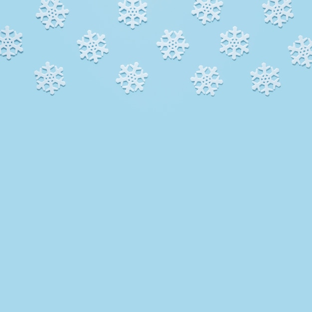 Snowflake on baby blue background with copy space