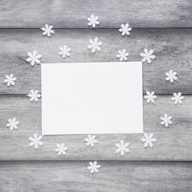 Snowflakes around paper sheet