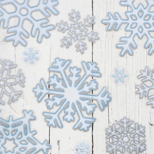 Snowflakes over a white wooden background