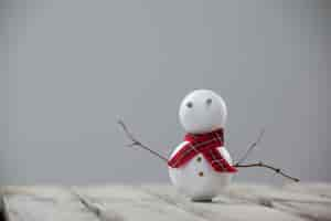 Free photo snowman on a wooden table