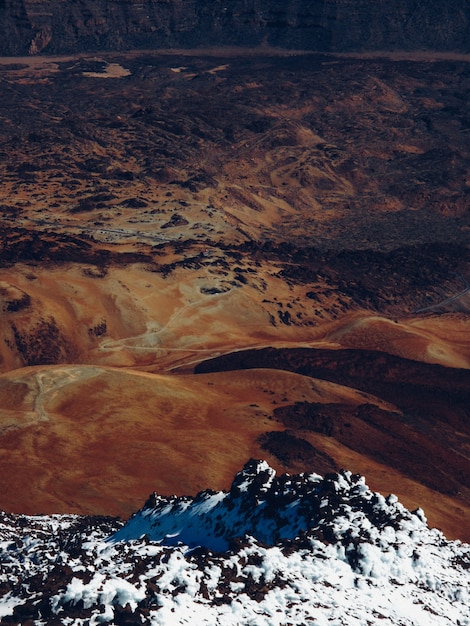 Snowy mountain near dry hills