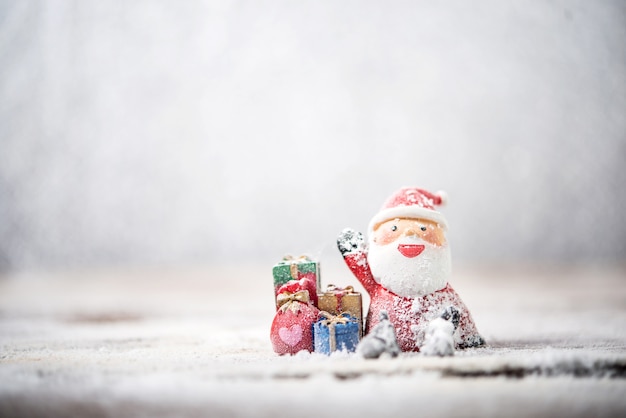 Snowy santa claus with christmas gifts