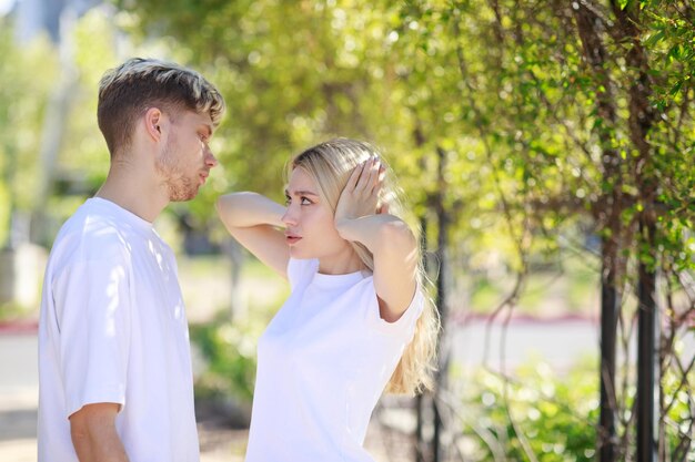 So put her hands on her ears and looking at her boyfriend