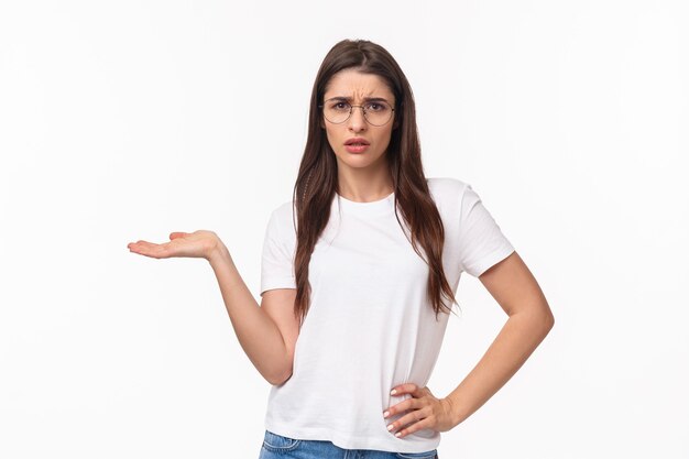 So what. Portrait of careless and unbothered, arrogant brunette woman in t-shirt