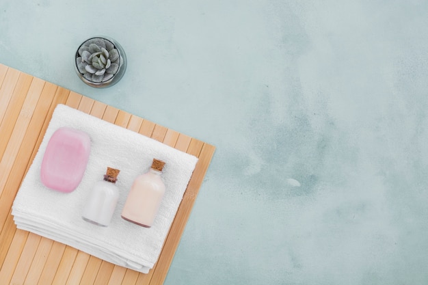 Soap bar and bath products on towel with copy space