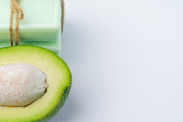 Soap bar with avocado on white background