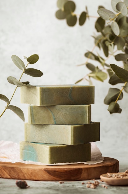 Soap and plants arrangement on wooden board