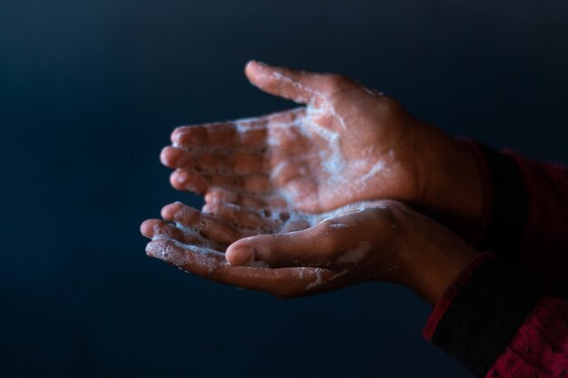 Soaped hands of a person - importance of washing hands during the coronavirus pandemic
