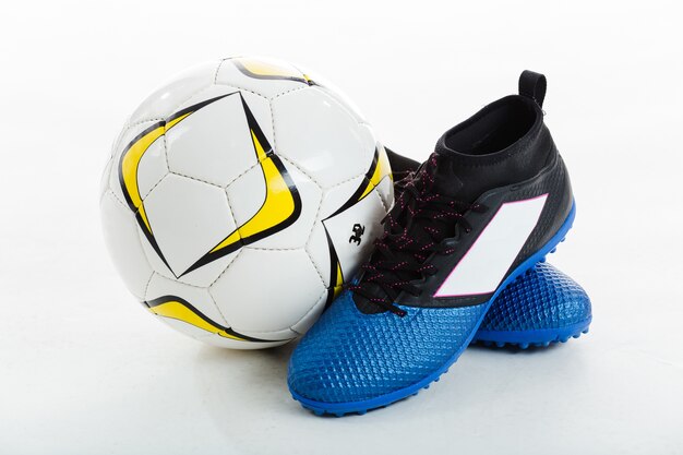 Soccer ball next to cleats