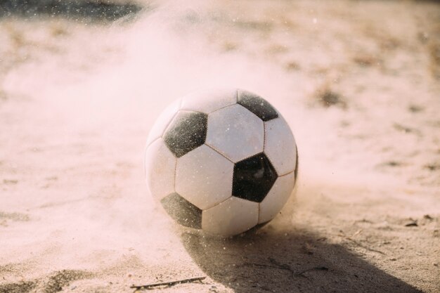 Soccer ball and sand particles