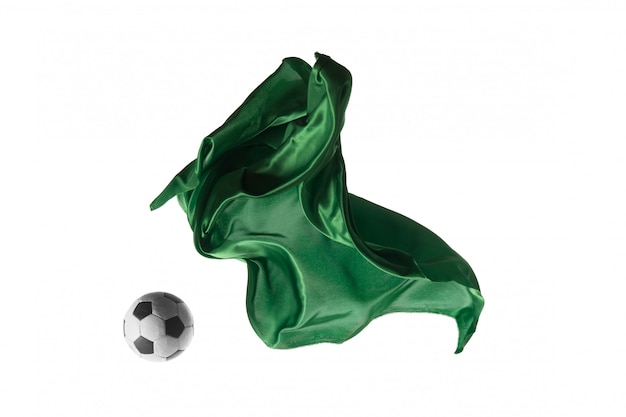 Футбольный мяч и гладкая элегантная прозрачная зеленая ткань, изолированные или разделенные на белом