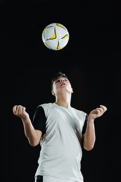 Soccer player playing ball with head