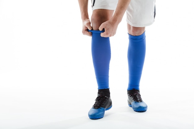 Soccer player putting on his socks