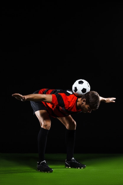 Free photo soccer player do tricks with ball