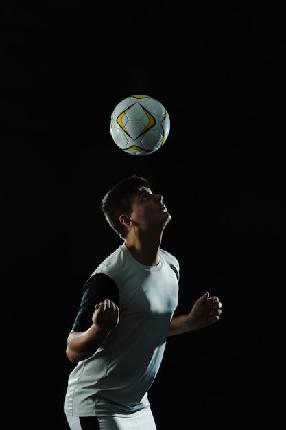 Soccer player using his head to hit the ball