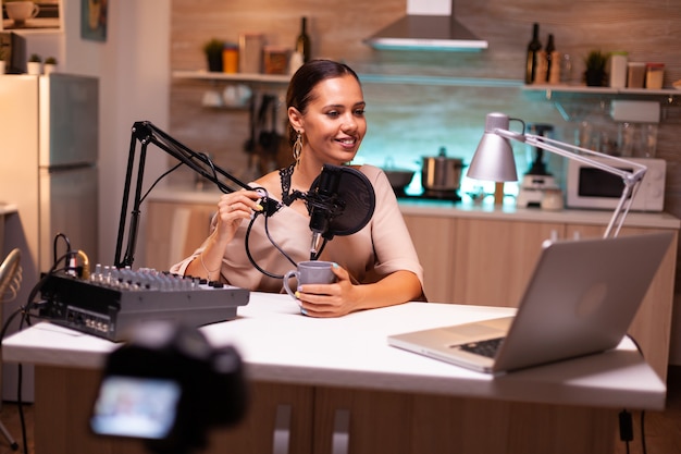 Social media analyst speaking on microphone during podcast, recording