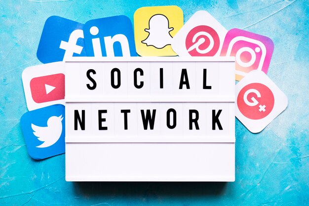 Social network text with networking application icons on painted wall