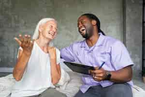 Free photo social worker taking care of an old woman