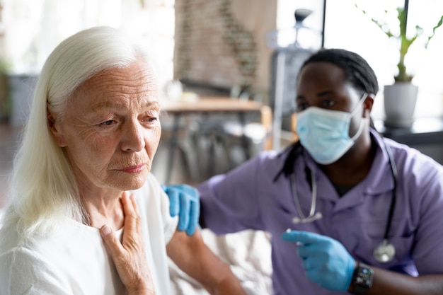 Social worker taking care of an old woman