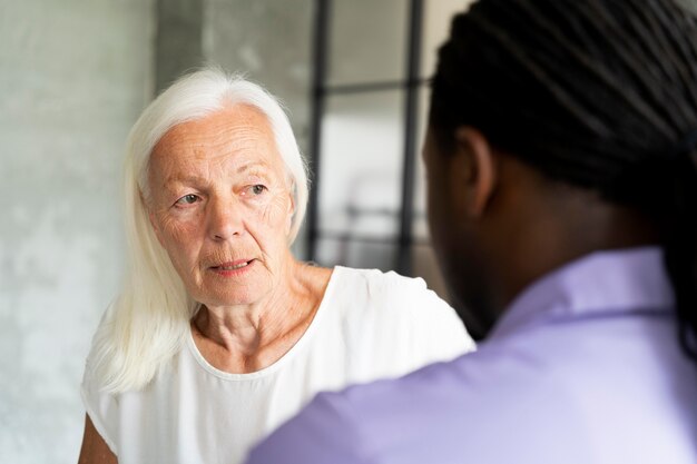 Social worker taking care of an old woman