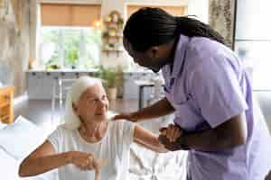 Free photo social worker taking care of an old woman