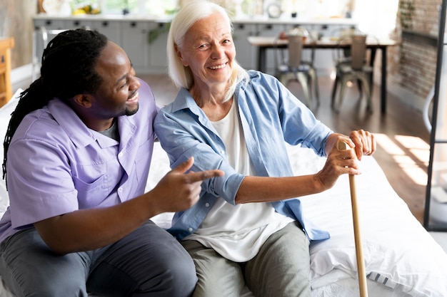 Free photo social worker taking care of a senior woman