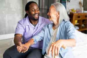 Free photo social worker taking care of a senior woman