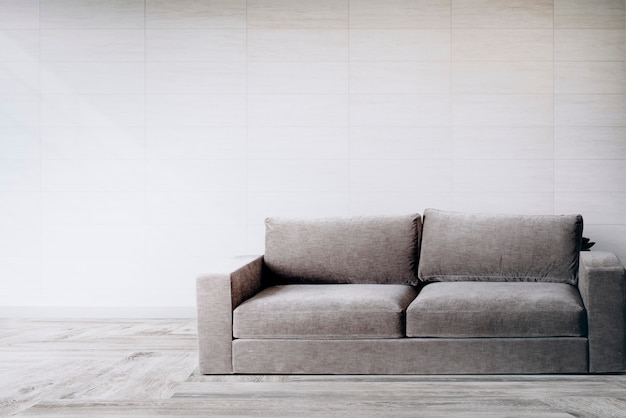 Sofa by a tiled wall