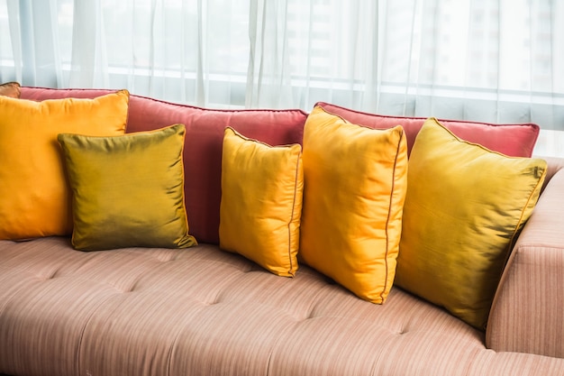 Sofa with cushions and white curtains background