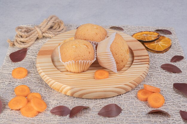 Soft cookies, rope and carrot slices on marble table. High quality photo