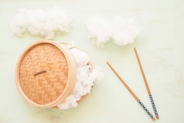 Soft cotton in steamer basket with chopsticks