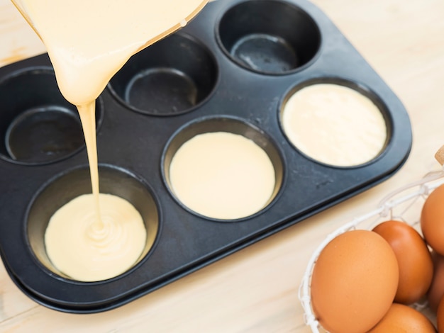 Soft focus of pouring liquid cake into a mold