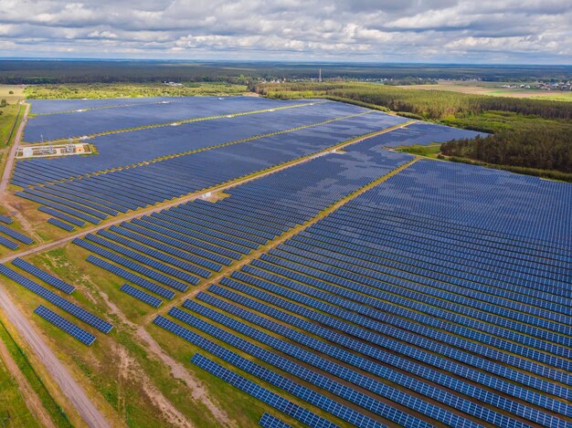 Solar panel produces green environmentaly friendly energy from the setting sun Aerial view from drone