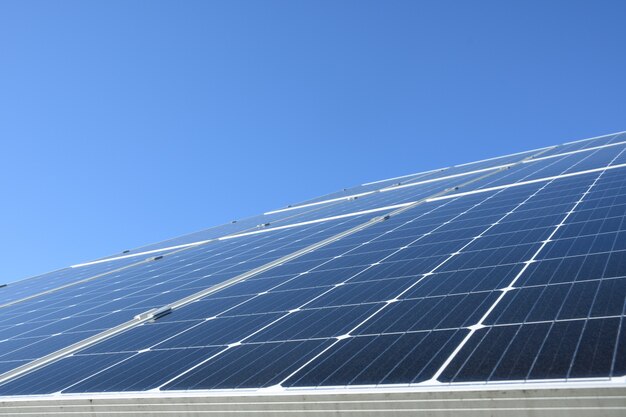 Premium Photo Solar Panels Against Blue Sky Background Against The Deep Blue Sky In A Suny Weather