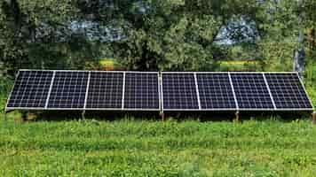 Free photo solar panels on the ground in the nature. greenery around