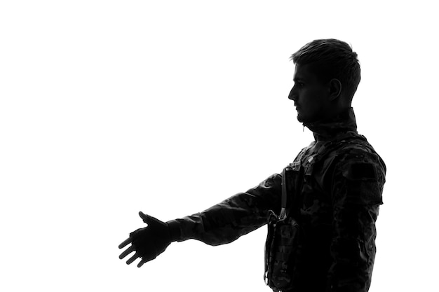 Soldier silhouette handsome serious strong tough army soldier in uniform giving handshake